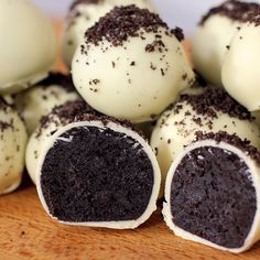 some white and chocolate desserts on a wooden table