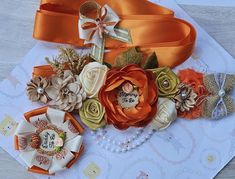 an assortment of flowers and ribbons on top of a piece of paper with beading