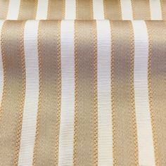 a close up view of a tan and white striped fabric