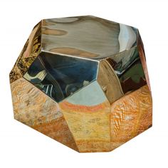 an octagonal shaped object made out of wood and metal with different colors on it's sides