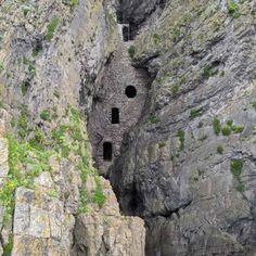 an old stone building built into the side of a mountain