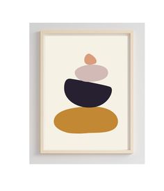 a framed print with rocks on top of it in black, white and orange colors