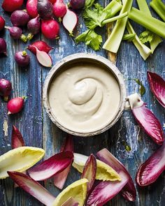 an assortment of vegetables including celery, radishes and dip