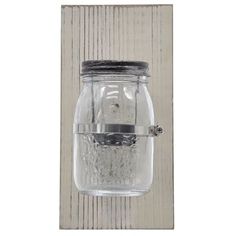 a glass jar hanging on the wall