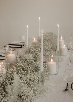 the table is set with candles and flowers