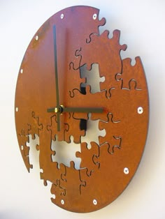 a clock made out of puzzle pieces on a wall