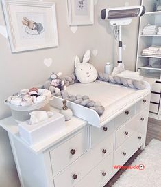 a baby's room is decorated in white and gray