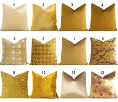 gold and white pillows with different designs on them, all lined up in the same row