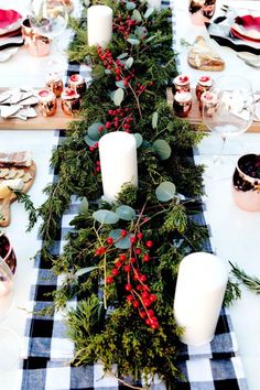 the table is decorated with greenery and candles