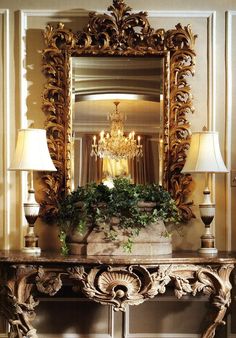 an ornate console with a potted plant on it