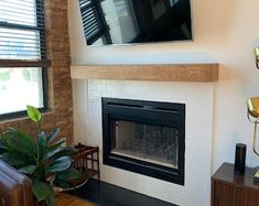 a living room with a television mounted above the fireplace