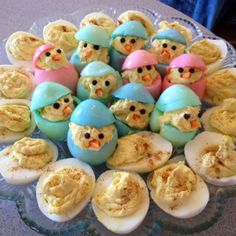 there are many deviled eggs with little chicks in them on the glass platter