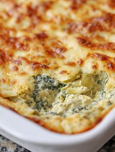 a casserole dish with spinach and cheese