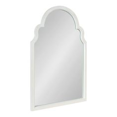 a white wall mirror with an arch shaped design on the top and bottom corner,