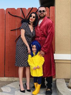 a man, woman and child dressed up in costumes