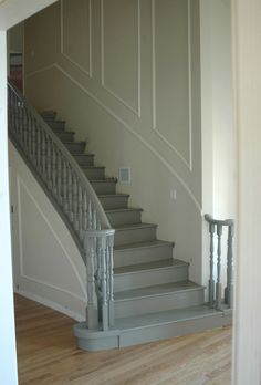 an empty room with stairs leading up to the second floor