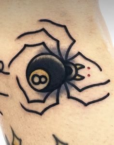 a close up of a tattoo with a spider on it