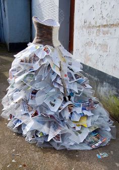 a dress made out of newspaper sitting on the ground