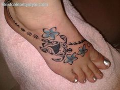 a woman's foot with butterfly tattoos on it