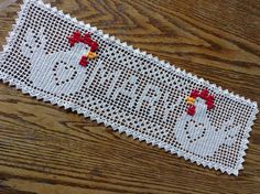 a close up of a piece of cloth on a wooden surface with the word hello kitty written across it