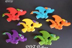 six different colored felt sea creatures on a black surface