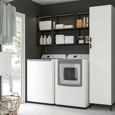 a washer and dryer sitting in a room next to a door with open shelves