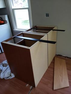 an unfinished kitchen counter being built in the middle of a room with hard wood flooring