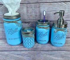 blue mason jars with gold lids and soap dispenser, toothbrush holder and tissue dispenser