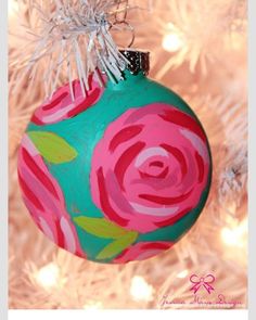 a painted ornament hanging from a christmas tree