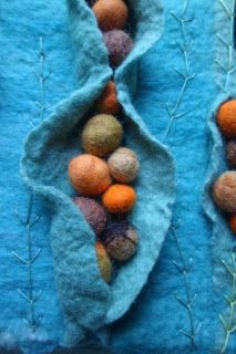 two pieces of felt with oranges on them