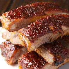 ribs covered in bbq sauce on a white plate