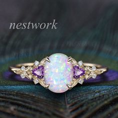 ♠ Item Info: The default one is solid 14k gold with lab opal. ✦ Center stone: 7x9mm oval lab opal. ✦ Side stones: Trillion 3mm amethyst and 1.3mm moissanites or real diamonds. ✦ Band width: about 1.4mm. About Option Box(Gold Karat-Side Stones): Gold Karat: 10k,14k or 18k. Choose platinum or silver when you're nickle allergic. Stones: The Center stone is a hexagon blue sandstone. Side Stone will be black spinels, moissanites or diamonds. ♠ Custom order,rush order or payment plan accepted. ♠ Processing Time: All items are made to order by hand made,which need 2-3 weeks processing time of handmade craft after we receive your payment. For special design one,it may need 1 month. ♠ We offer 30 days warranty on all of our items.The stones on out shop are incredibly strong and sturdy. For any ques Purple Opal Promise Ring, Elegant Purple Opal Ring For Anniversary, Elegant Purple Opal Anniversary Ring, Cluster Diamond Ring, Engagement Ring Women, Diamond Ring Engagement, Ring Cluster, Blue Sandstone, White Opal Ring