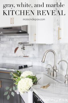 a white and marble kitchen reveal with flowers in the center on the sink countertop