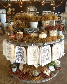 a display in a store filled with lots of signs and pumpkins on the table