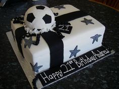 a birthday cake with a soccer ball and stars on the top is for a 21st birthday