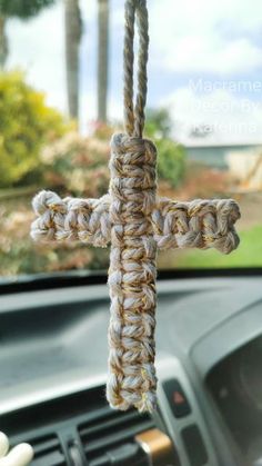 a close up of a car steering wheel with a cross on it