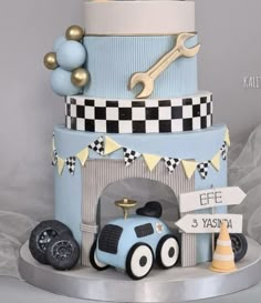 a three tiered cake with cars on it