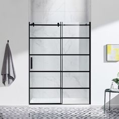 a bathroom with marble tile flooring and white walls, including a glass shower door