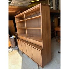 a large wooden bookcase sitting inside of a room