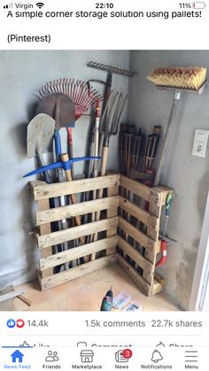 a wooden crate filled with gardening tools on top of a floor next to a wall