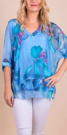 Floral Bloom Design on 100% Silk Blouse with Frayed Raw Edge Hemline. Soft, Stretchy Viscose Layer Underneath. 100% Silk Exterior | 95% Viscose | 5% Elastic Interior Made in Italy Fits Sizes XS- XL Model 5'7 Light Blue Floral Print Blouse For Vacation, Printed Blue Tunic For Spring, Blue Floral Print Tops For Vacation, Blue Printed Top For Vacation, Blue Printed Tops For Vacation, Spring Blue Printed Tops, Spring Vacation Blue Blouse, Blue Blouse For Spring Vacation, Blue Printed Tops For Spring