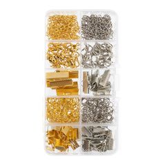 an assortment of gold and silver metal hardware in a plastic container on a white background