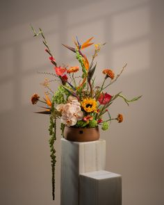 a vase filled with lots of different types of flowers