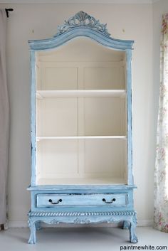 an old blue china cabinet in the corner of a room