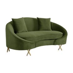 a green couch with two pillows on it and some gold legs in front of the couch