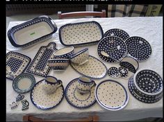 a table topped with lots of blue and white dishes covered in polka dot design plates