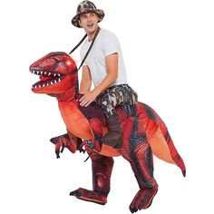 a man riding on the back of a dinosaur costume