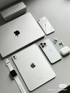 an apple product is displayed on a table next to other devices and accessories, including the new macbook air