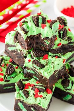 there are many brownies with green frosting and red sprinkles on them