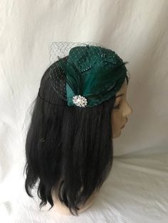 This is a classy vintage inspired 1950s - 1960s Dark emerald green half hat with a modern touch perfect summer fascinator as a bridal fascinator hat, mother of the bride hat, wedding hat, tea party hat, church hat or special occasion hat. This is a dark emerald or teal green headpiece create by hand and has a wire base that can fit any head size comfortably. WHAT MAKES THIS SO UNIQUE I form each piece while on my head to see how it fits and looks and then take it off and hand pleat and sew each Green Hat Fascinator For Wedding, Emerald Green Fascinator Hat, Adjustable Green Fascinator Hat, Green Evening Fascinator Hat, Elegant Green Hat Headpiece, Green Headpiece, Bride Fascinator, Special Occasion Hats, Mother Of The Bride Hats